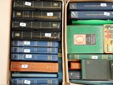 a lot of books in a box with labels on them