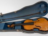 an old violin case with a violin in it on a white surface