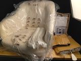 a chair that is wrapped in plastic and sitting on a table