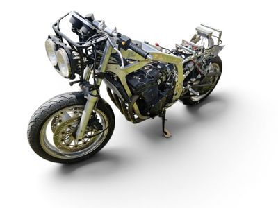 a motorcycle that is sitting on a white surface