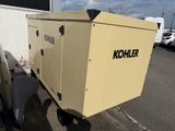 a small generator on the back of a truck in a parking lot