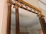 a large mirror in the corner of a room