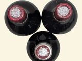 three bottles of wine sitting on top of each other