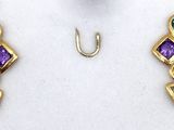 two pairs of gold earrings with multi colored stones on a white surface