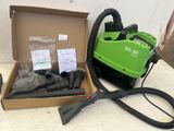 a green blow dryer sitting in a box next to other items