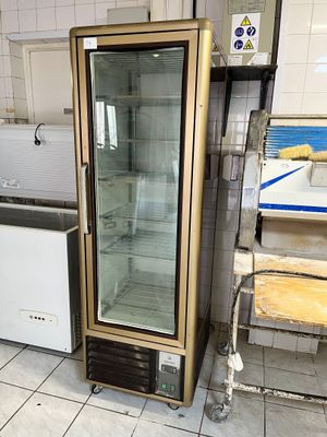 un réfrigérateur avec une porte en verre dans une cuisine