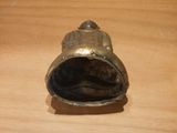a small metal bell on a wooden table