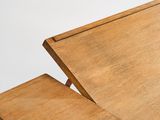 a close up of a wooden table with a drawer on it