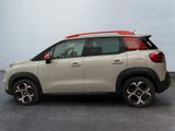 the rear of a white car with a red roof rack on top of it