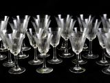 a lot of wine glasses that are lined up together