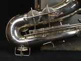 a close up of a silver saxophone on a black background