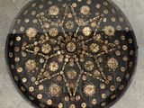 an image of a black and gold circular table