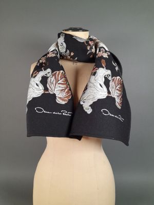 a black and white scarf with white flowers on it