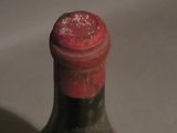a small bottle with a label on it sitting on a table