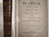 an old book with a brown cover sitting on top of a table