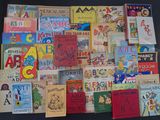 a lot of children ' s books on display on the table
