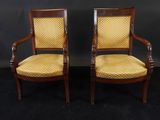 a pair of antique chairs with yellow upholstered upholstered cushions