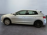the rear view of a silver car in a showroom
