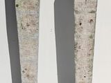 two pieces of wood sitting on a white surface