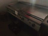 a silver stove top in the corner of a kitchen