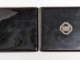 an image of a black box with a silver ring on top of it