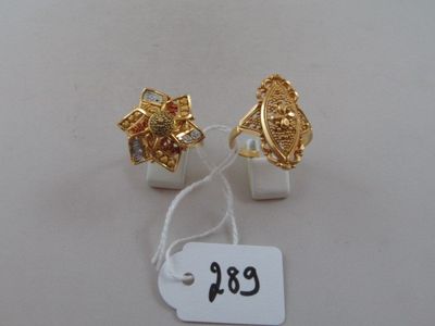 two pairs of gold tone earrings with red and white stones