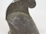 an old helmet that is sitting on a white surface
