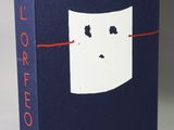 the book is blue and white with a face drawn on it