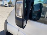a close up of a car ' s side mirror with a car in the background