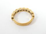 a close up of a gold ring on a white surface