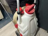 a man that is standing next to a white and red spray can