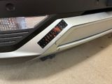 a close up of a car with a clock on the bumper