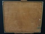 painting on a wooden easel against a black background