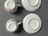 three cups and saucers sitting on a table