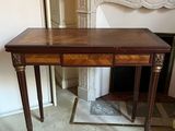 a small table with a drawer on it in a room