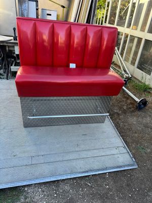 a red bench that is sitting on the ground