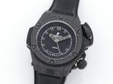 the watch is black and has a black rubber band