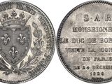 a close up of a coin with a coat of arms on it