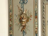 two paintings of birds hanging on the wall above the stairs