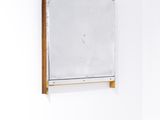 a mirror hanging on the wall in a white room