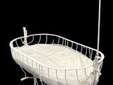 a white baby crib with a white blanket in it