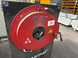 a red machine that is sitting in a warehouse