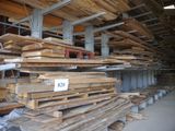 a large amount of lumber stacked up in a warehouse