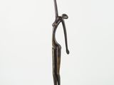 bronze statue of a woman holding a knife on a white background