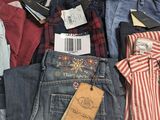 several pairs of men ' s jeans are stacked on top of each other