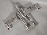 a small metal airplane with writing on the side of it