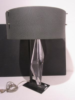 a lamp that is sitting on a table next to a wall