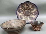 two bowls and a bowl sitting on a table