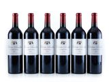 six bottles of red wine are lined up in a row