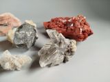 several different types of rocks and crystals on a white surface